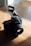 A sleek, high-end camera resting on a polished wooden table with soft natural light.