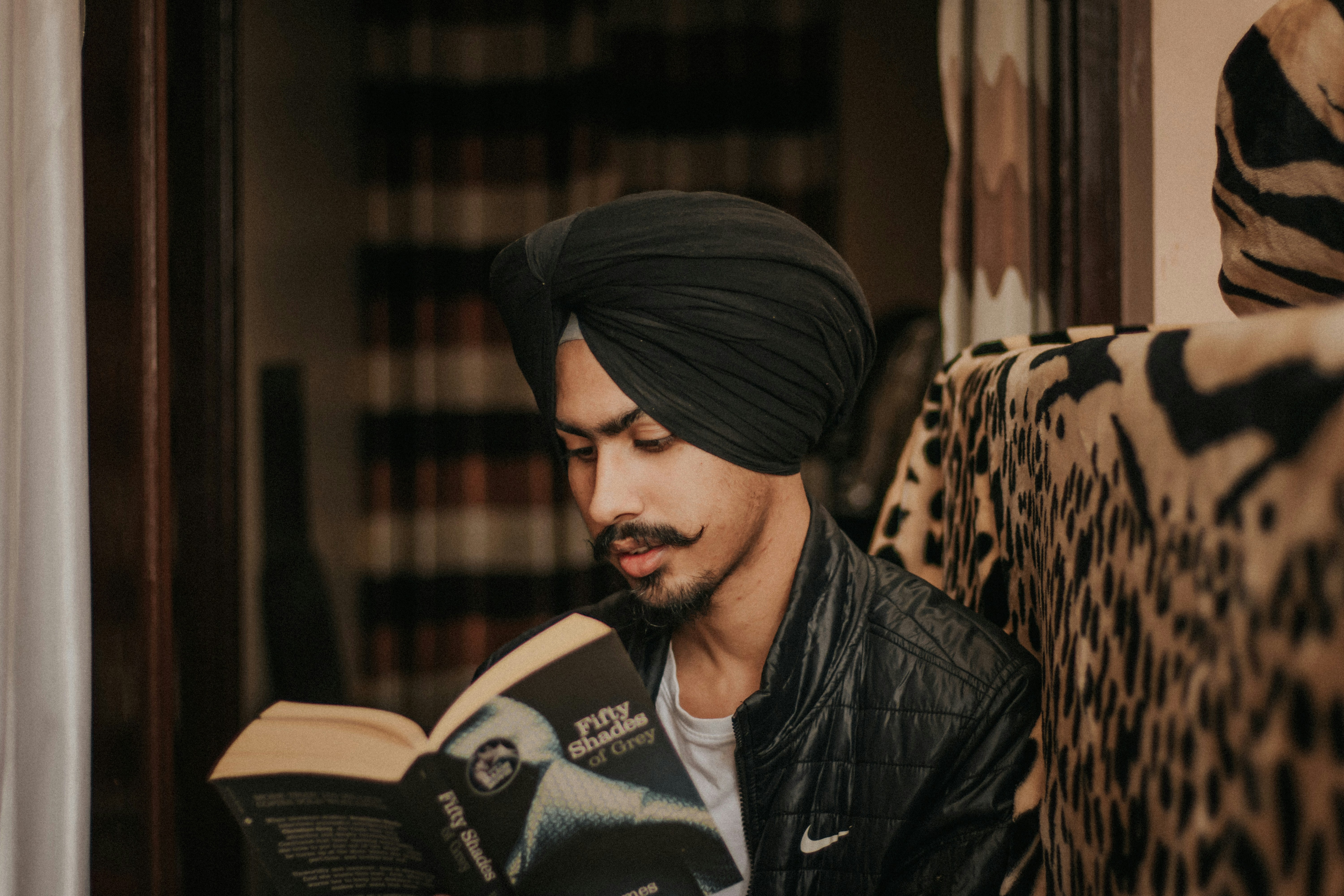 A young sikh boy reading book during quarantine and spending quality time