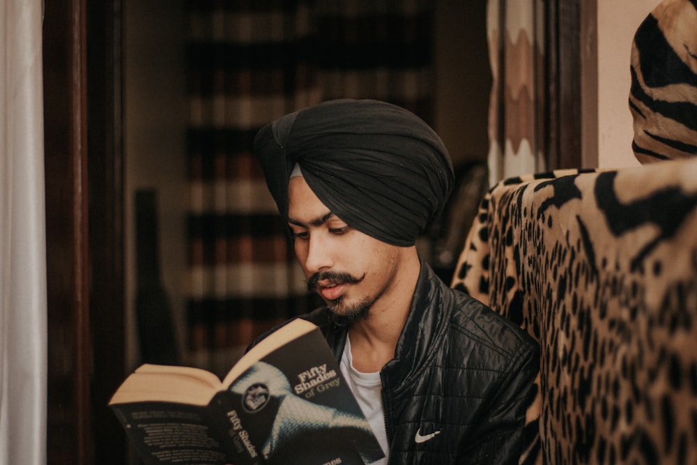 man in black leather jacket and black knit cap