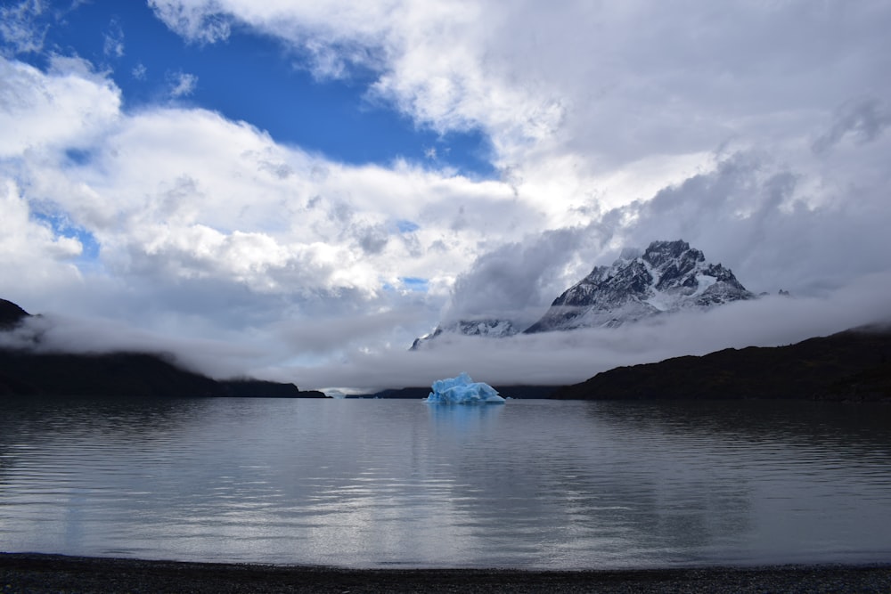 body of water under white clouds and blue sky during daytime