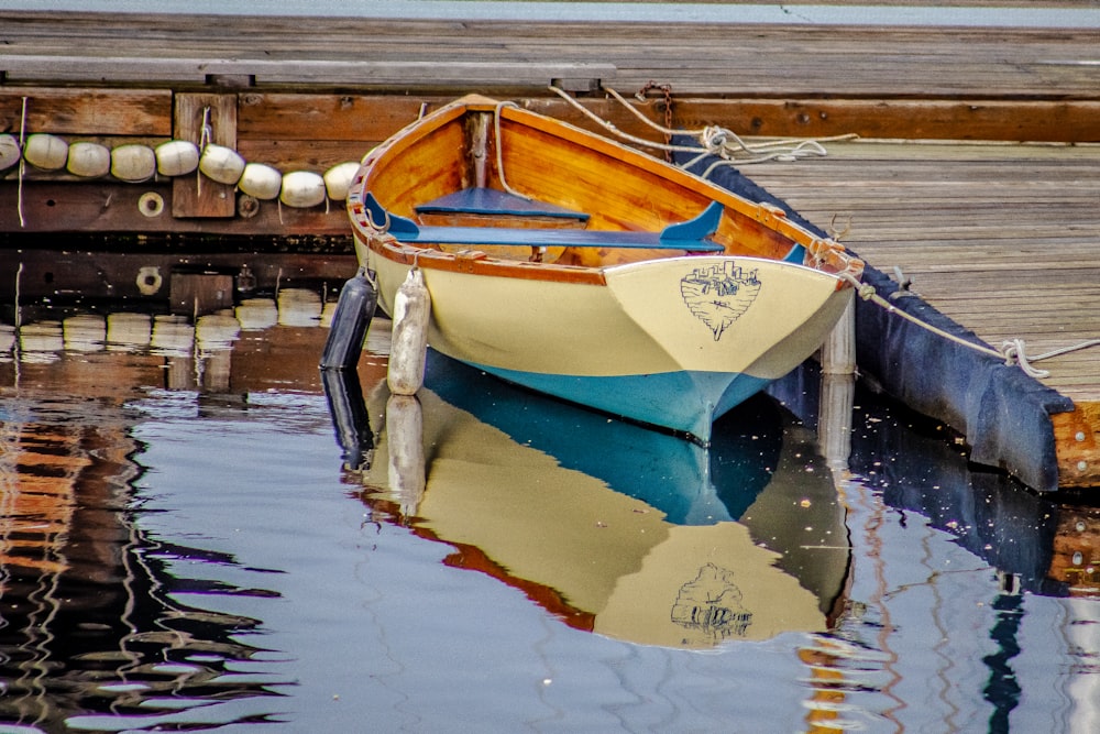 white and blue boat on water