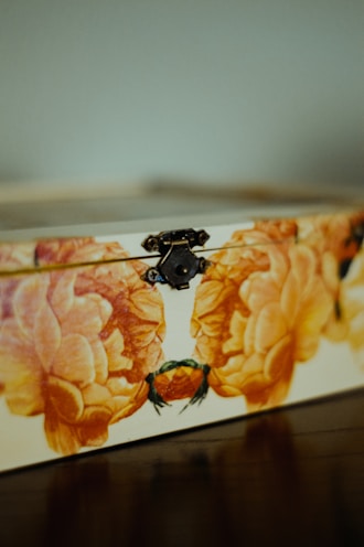 A close-up of a custom engraved keepsake box with delicate floral designs.