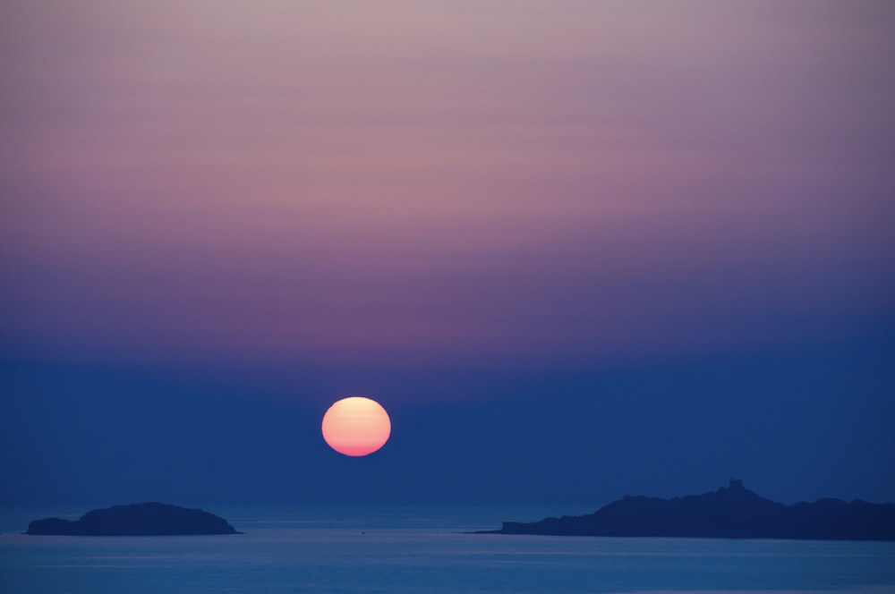 body of water during sunset