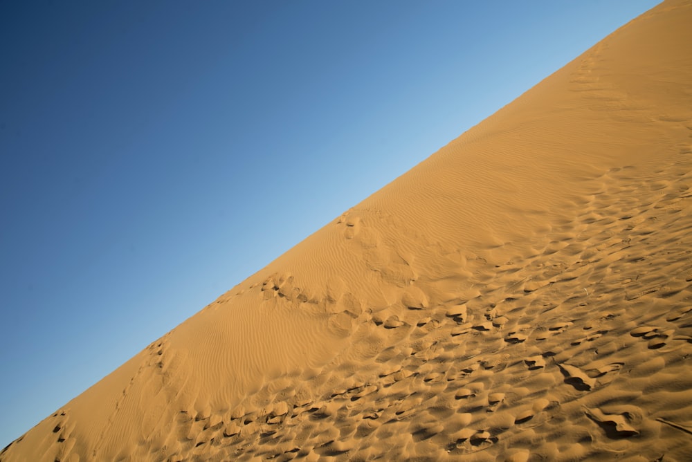 brown sand under blue sky during daytime