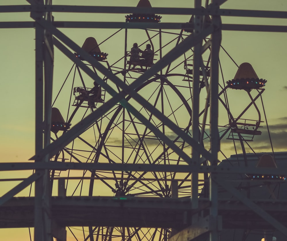 silhouette of people on top of tower