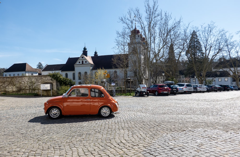 red station wagon parked on parking lot during daytime