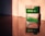 Two boxes of Fujifilm camera film sit on a reflective surface, with warm, soft lighting casting shadows and highlights. The top box is labeled 'FUJIFILM Superia X-TRA 400', and the bottom one is marked 'FUJICOLOR C200'. The labels are clearly visible, and the reflection enhances the warm tones.