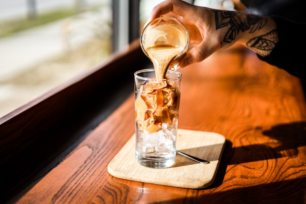 clear drinking glass with ice and ice