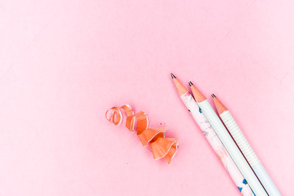 white and orange coloring pencils