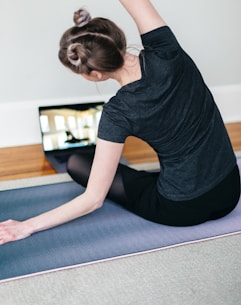Woman taking an online yoga teacher training course