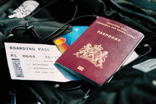 a passport and a boarding pass are on a bag