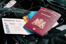 Passport and boarding pass placed on a travel bag