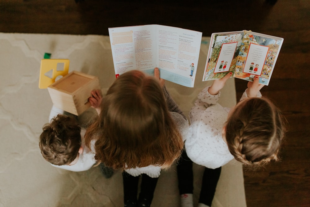 girl in white long sleeve shirt reading book