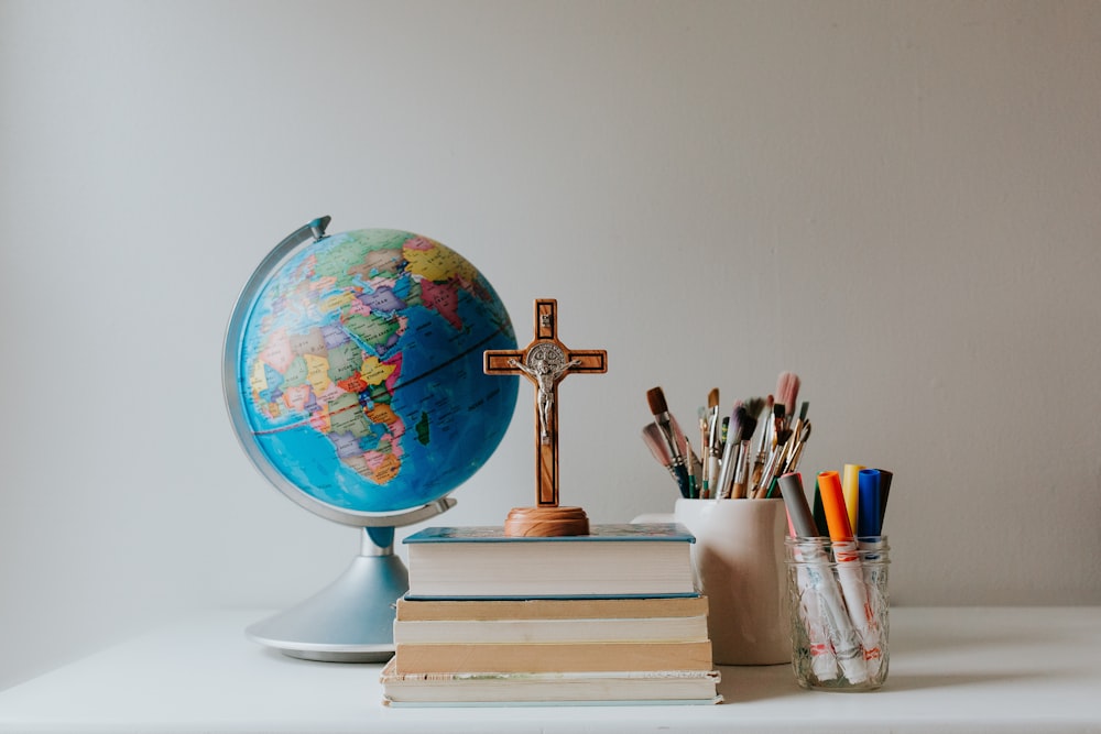 blue and brown globe on white book