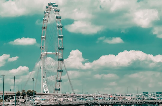 white and gray bridge under cloudy sky during daytime in Marina Bay Singapore
