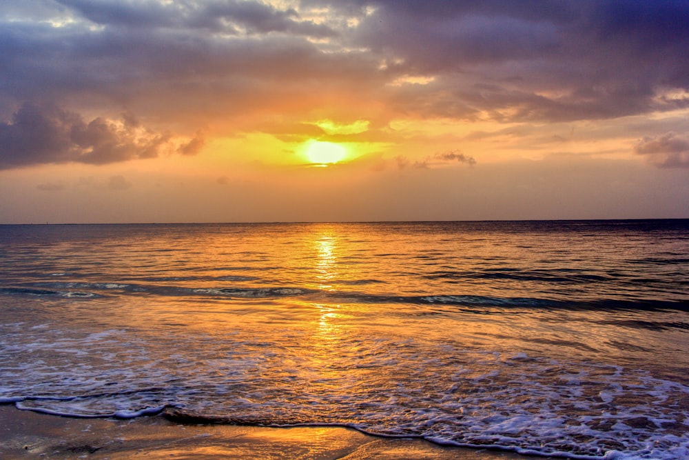 body of water during sunset