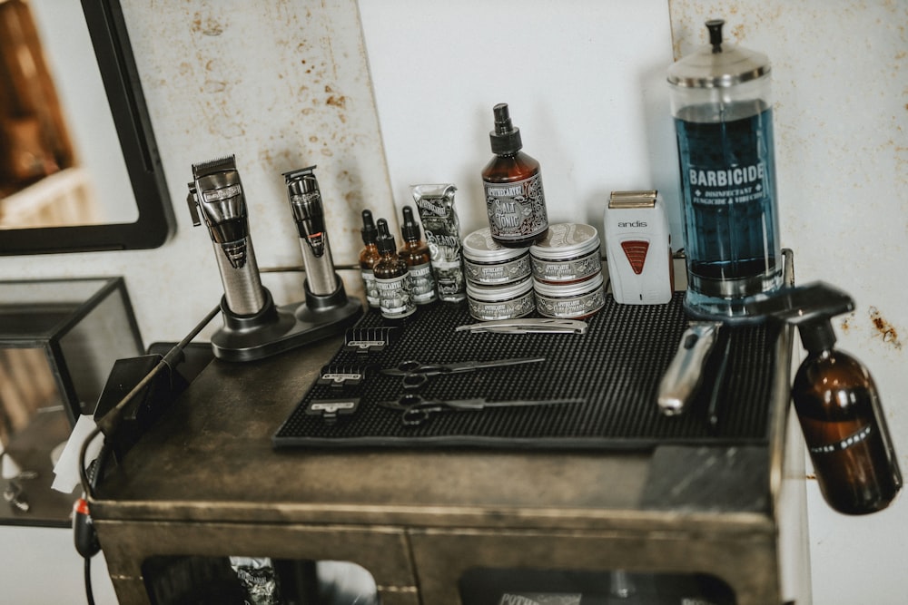 stainless steel condiment shakers on black metal tray