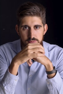 Thoughtful man posing with hands on his chin.