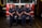 Firefighters standing proudly next to a Pavoni fire truck in front of a fire station