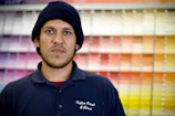 Close-up of a painter's cap and t-shirt with Inner Pro logo during a commercial space renovation.