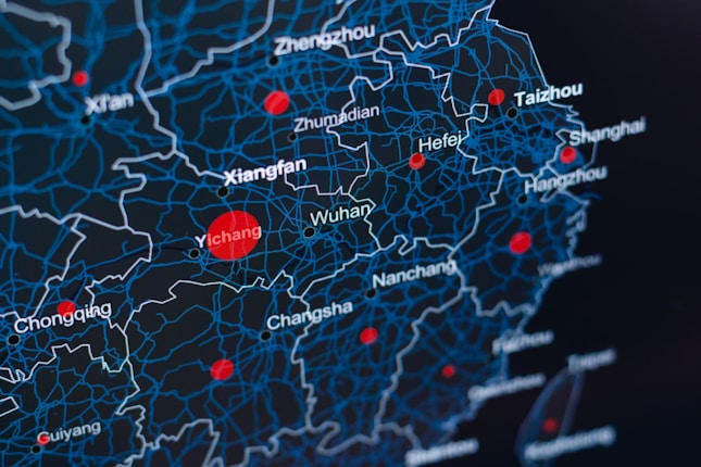 A digital map showcasing regions in China with a network of blue lines representing boundaries and red dots indicating key locations such as Wuhan, Xianfan, Hefei, and others. The background is dark, highlighting the contrast of the blue and red elements.