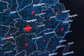 A digital map showcasing regions in China with a network of blue lines representing boundaries and red dots indicating key locations such as Wuhan, Xianfan, Hefei, and others. The background is dark, highlighting the contrast of the blue and red elements.