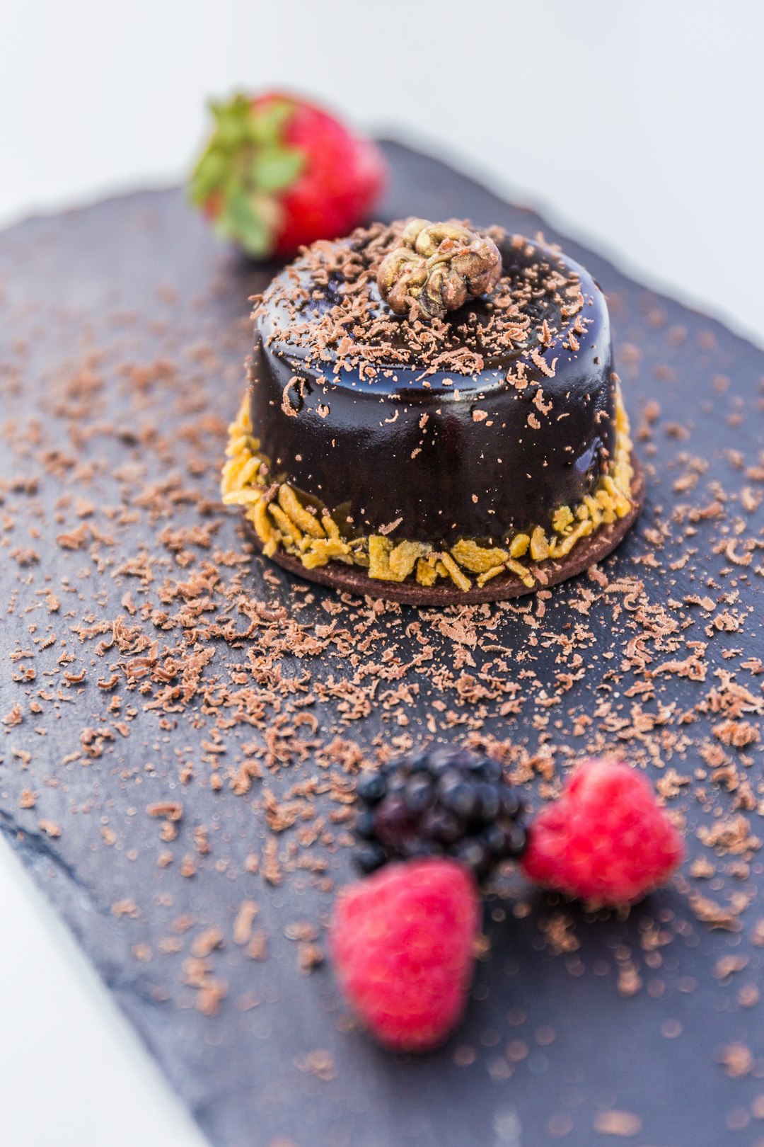 chocolate cake with raspberry and blueberry on top