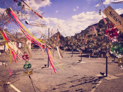 Colorful festival decorations hanging from trees at a free-party