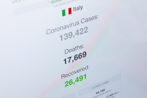 A digital display shows statistics regarding coronavirus cases in Italy, including the total number of cases, deaths, and recoveries. The numbers are clearly visible, with 'Coronavirus Cases' listed as 139,422, 'Deaths' as 17,669, and 'Recovered' as 26,491. The display includes the Italian flag and uses different colors to highlight each statistic.