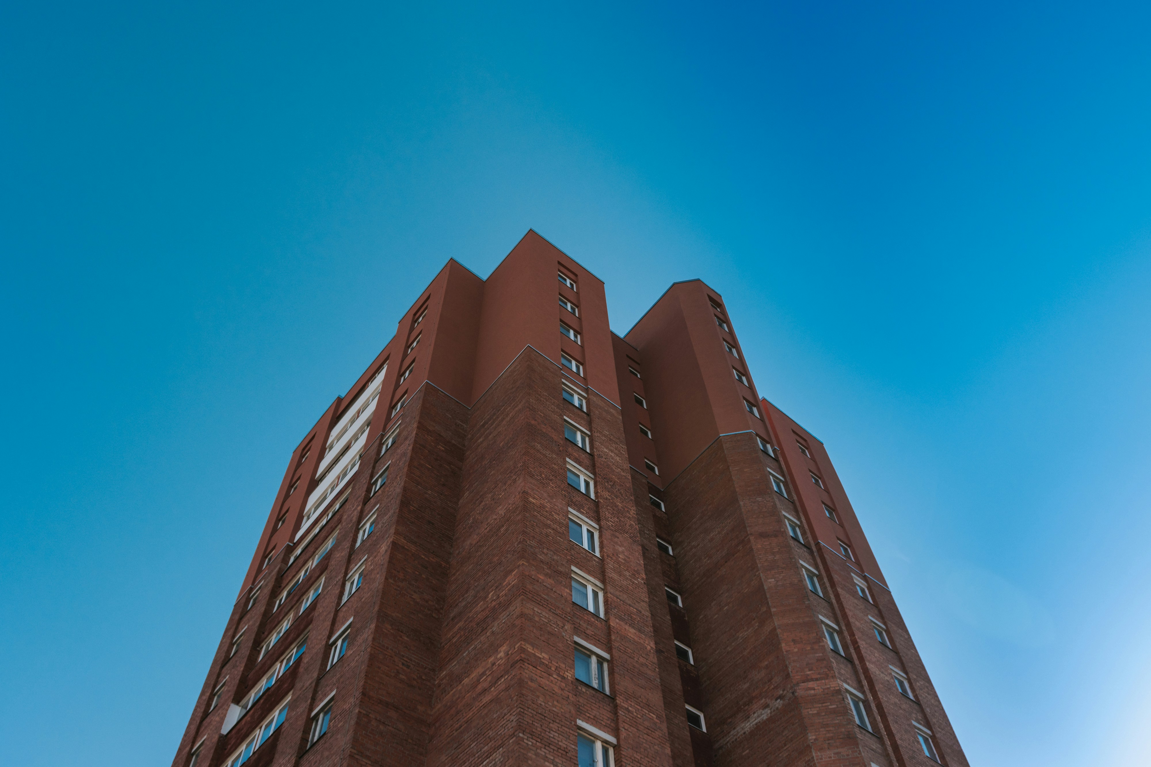 brown concrete building under blue sky during daytime estonia teams background