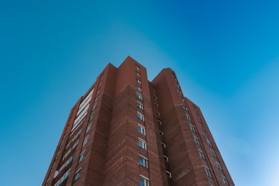 brown concrete building under blue sky during daytime estonia teams background