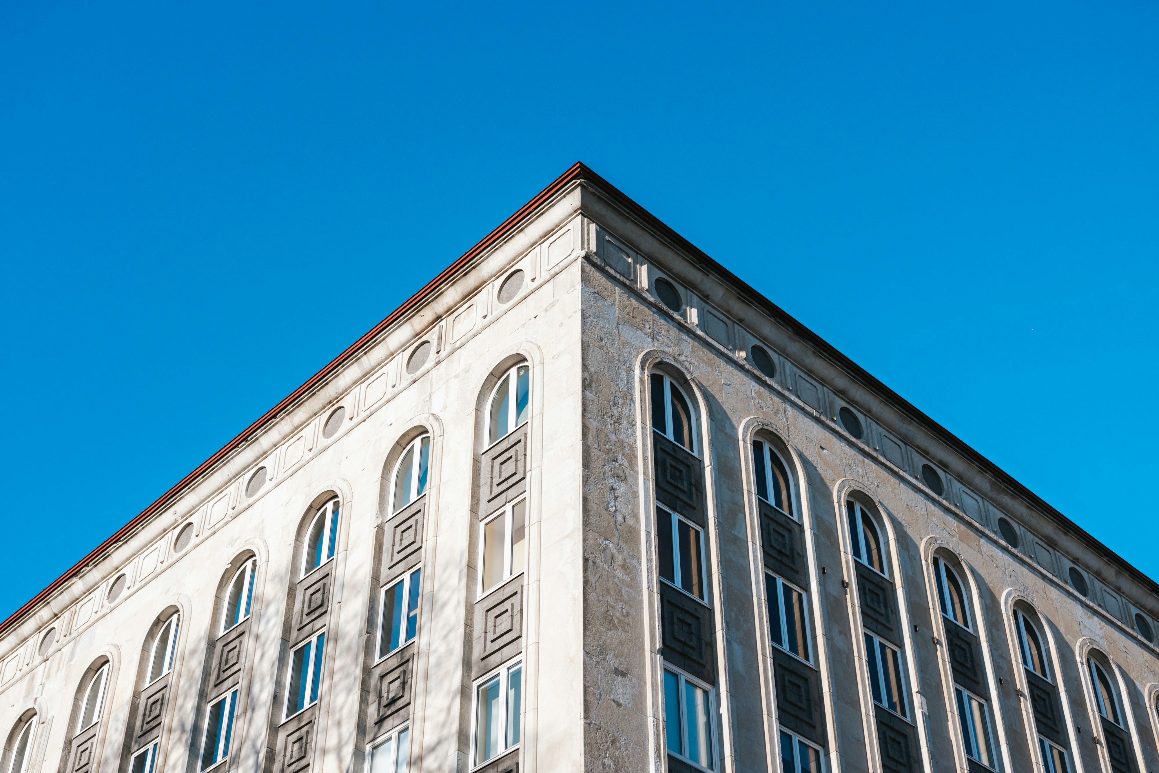 brown and white concrete building under blue sky during daytime