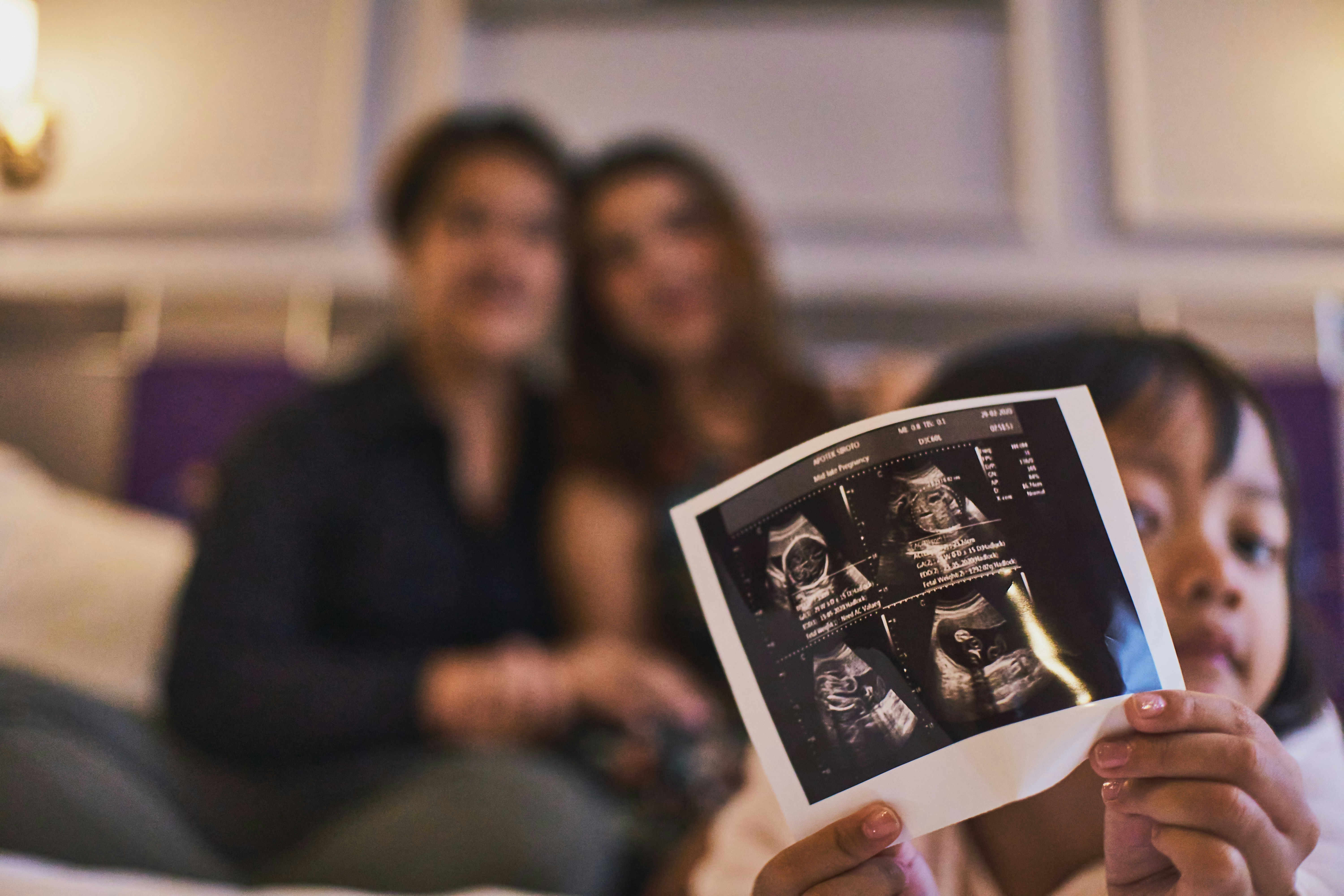 Mother viewing ultrasound image during postpartum follow-up visit