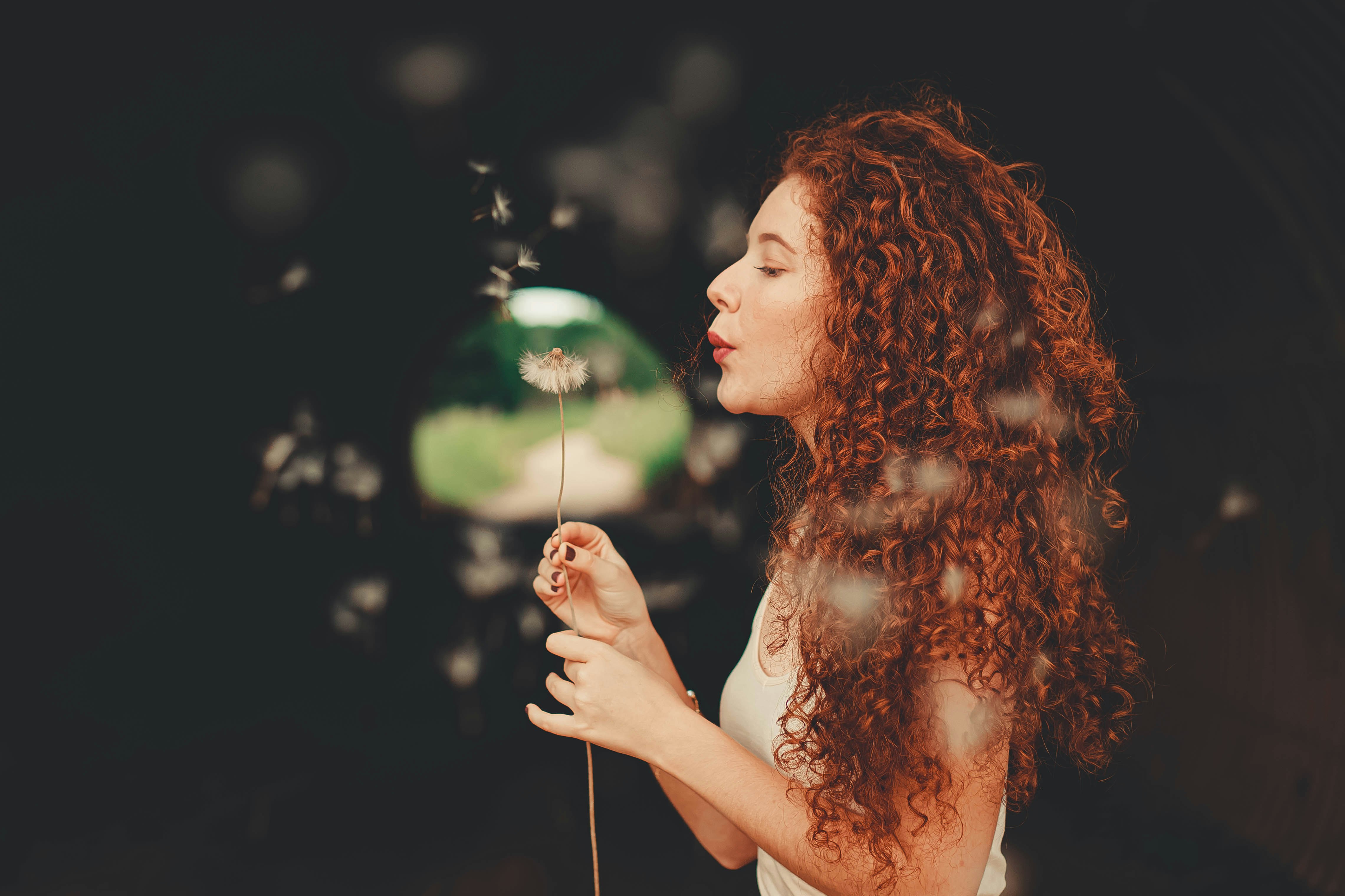 woman blowing bubbles during daytime