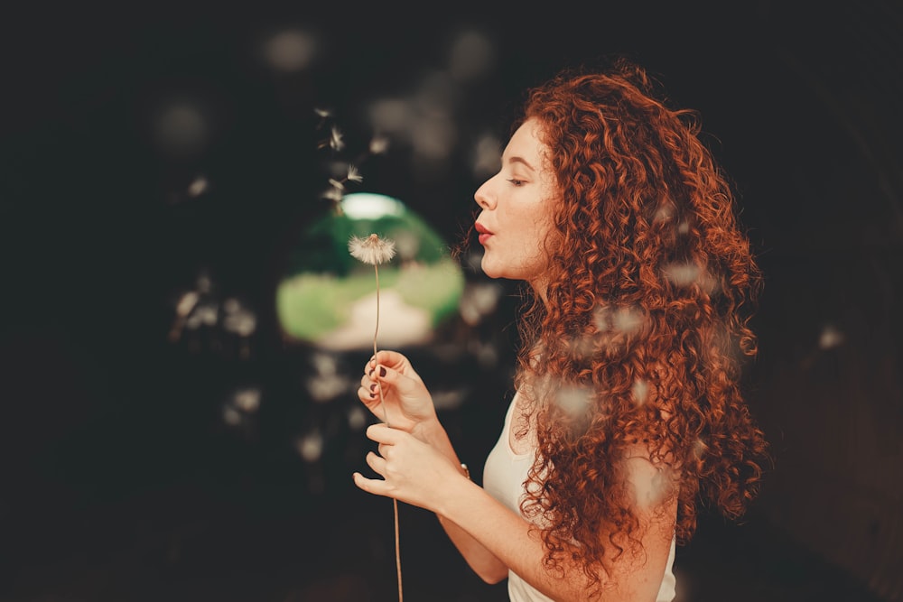 woman blowing bubbles during daytime