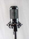 black and silver microphone on white textile