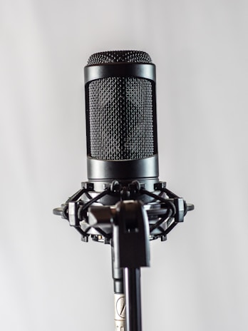 A close-up of a professional microphone on a stage.