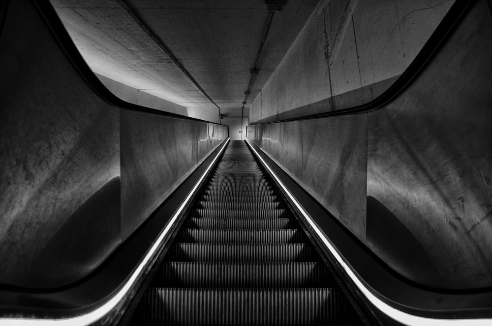 grayscale photo of a escalator