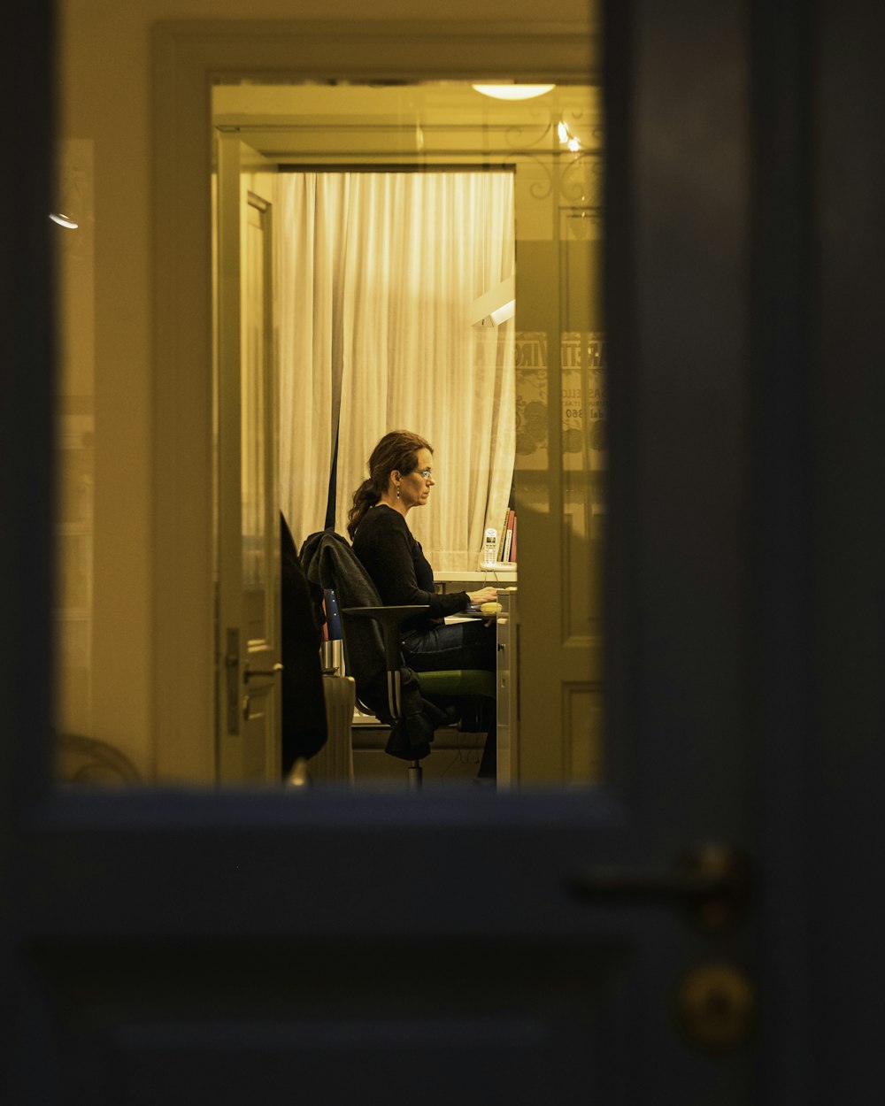 man in black jacket sitting on chair