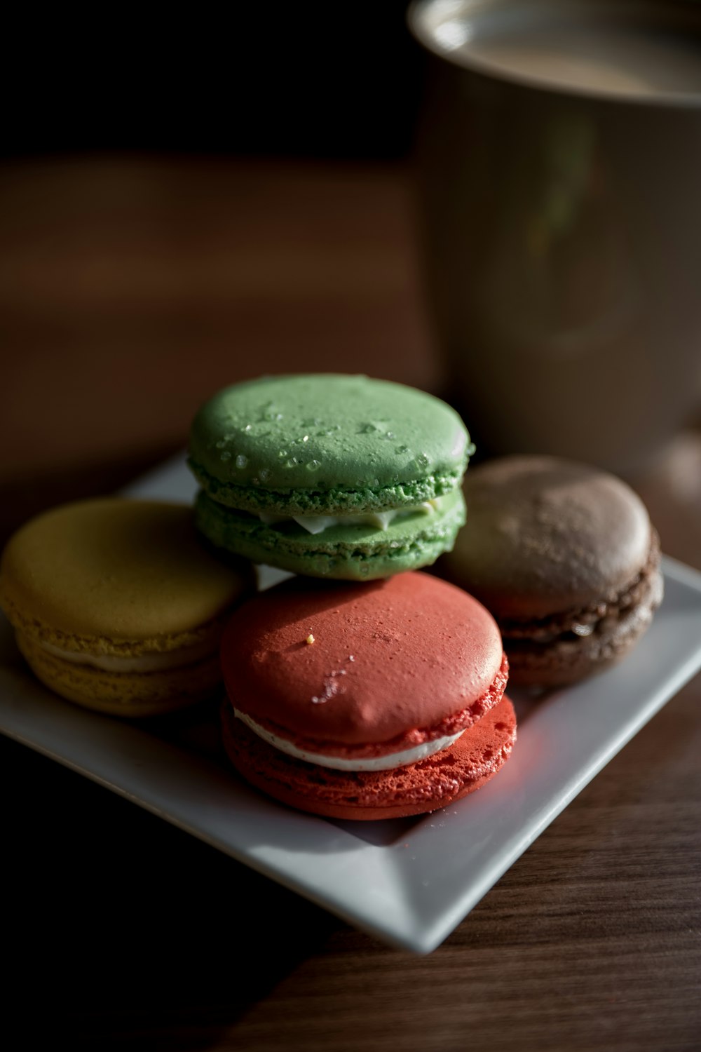 three brown and green cookies on white ceramic plate