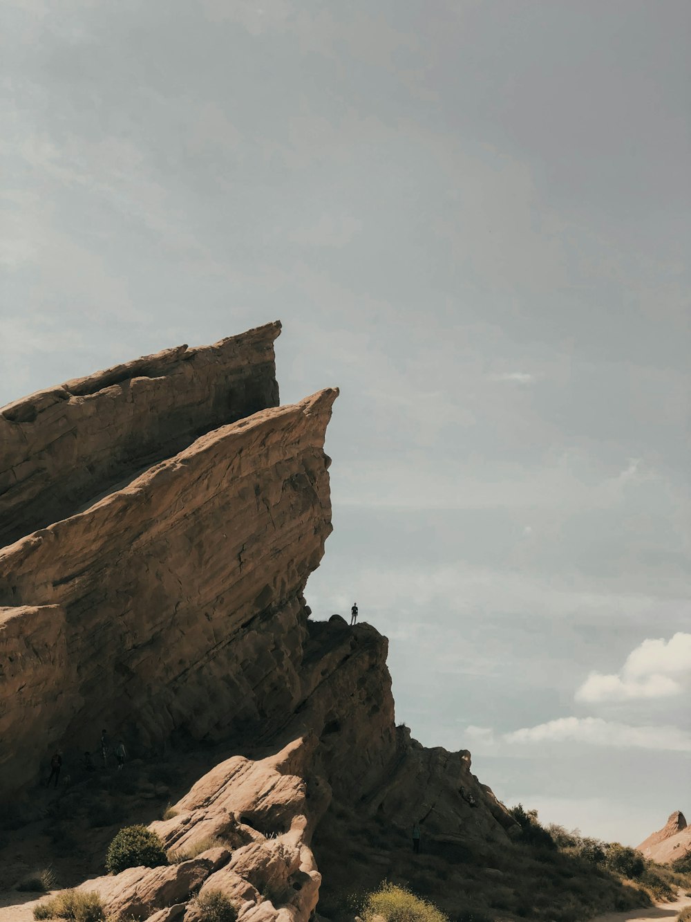 brown rock formation under white clouds during daytime