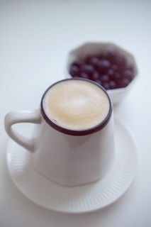 white ceramic mug with cappuccino