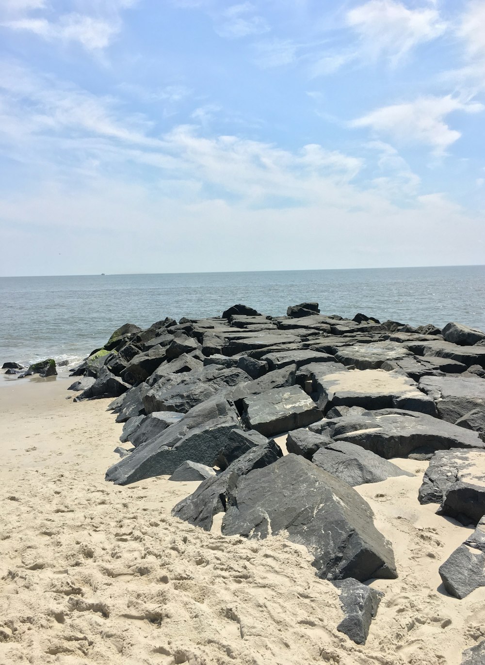 gray rocks on beach during daytime