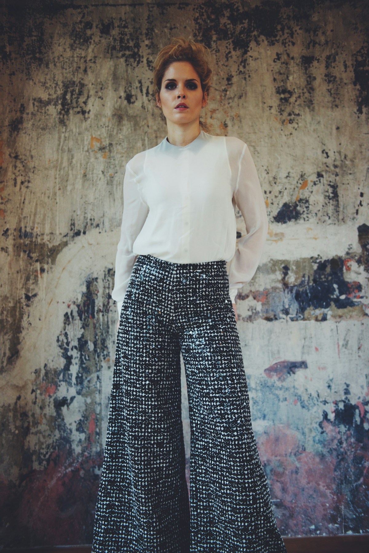 Atelier tailor finishing a Mercer wool trouser hem
