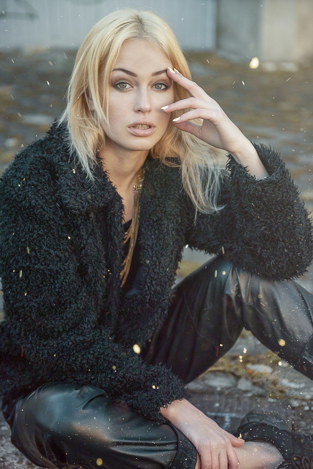 woman in black fur coat sitting on water