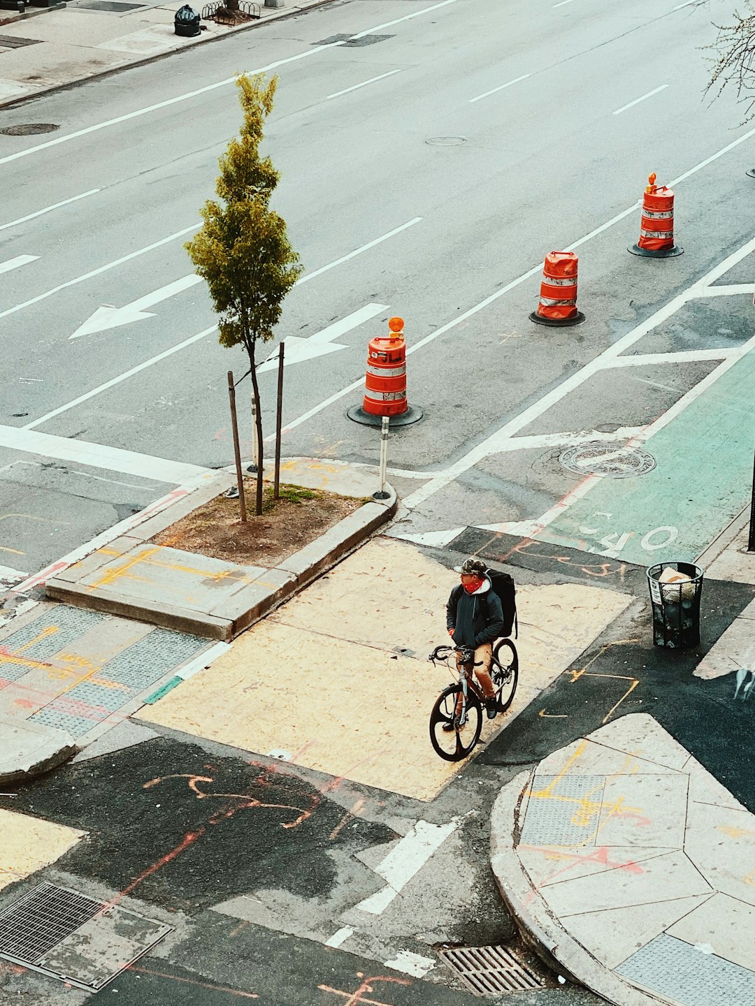 man in black jacket riding bicycle on road during daytime