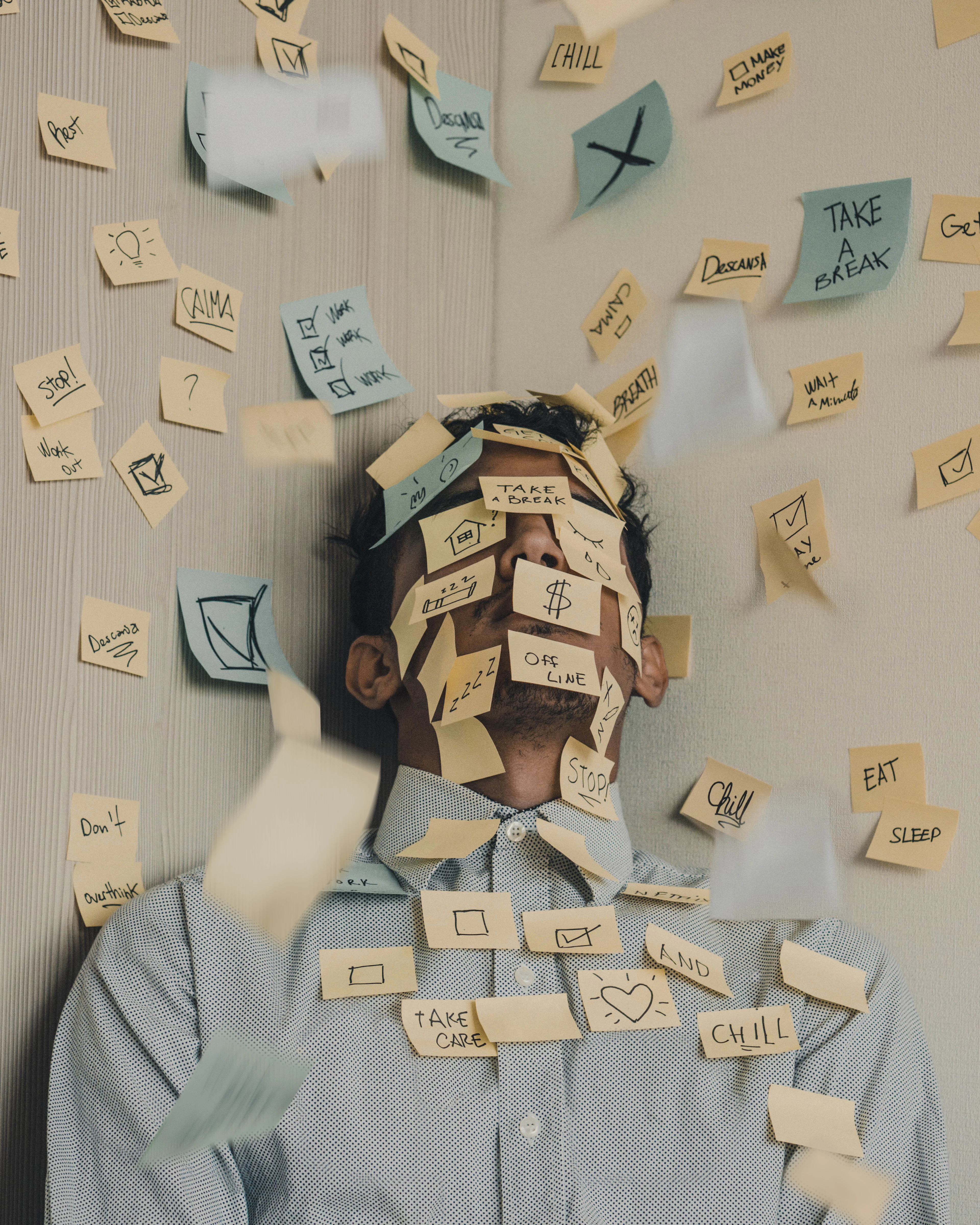 Overwhelmed office worker covered in sticky notes, a picture of the manual, paper-heavy work behind every account opening