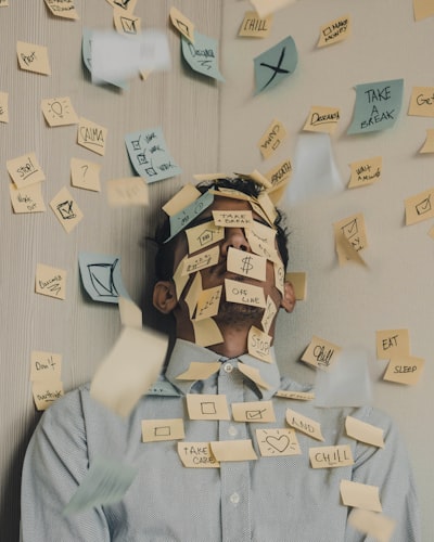 A person surrounded by sticky notes representing cognitive overload and the failure of willpower-based approaches for ADHD executive dysfunction