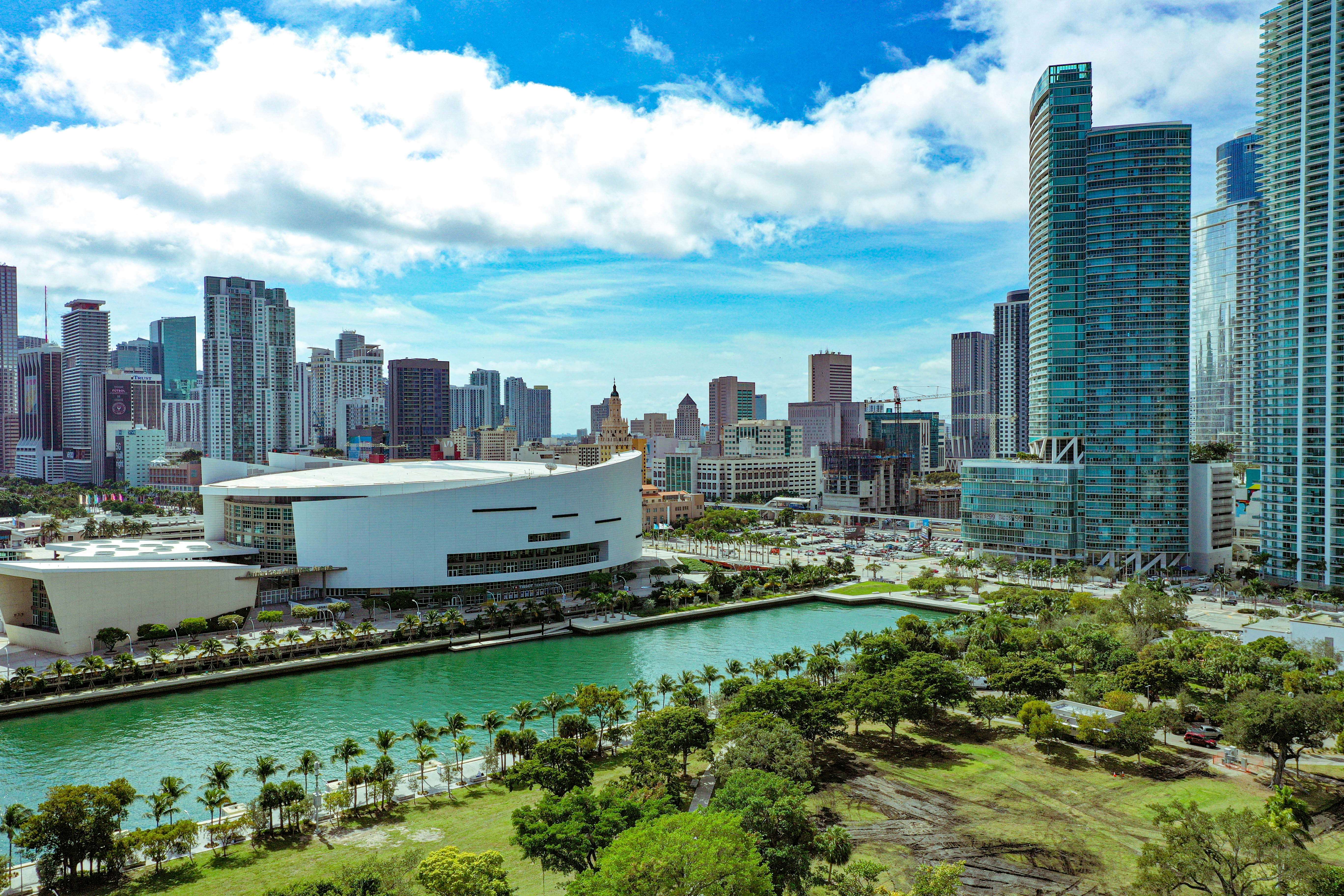 high rise buildings near green trees under blue sky during daytime