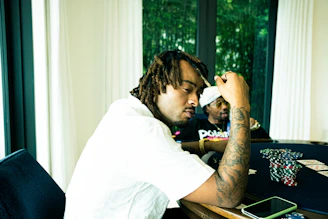 Side view of a sleek, modern poker table illuminated under ambient lighting.